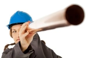 Woman in a blue hard hat holding a copper pipe, symbolizing plumbing services and repiping solutions for homes.