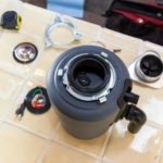 Disassembled turbocharger part with automotive components, showcasing precision for plumbing maintenance insights.