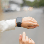 Smartwatch on a wrist, showcasing plumbing maintenance tips for homeowners during holidays by Allore's Plumbing Services.