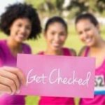 Three women in pink athletic clothing promoting health awareness, holding a card that says "Get Checked.