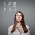 Woman thinking about plumbing tips, surrounded by question marks related to services in Stuart, FL.