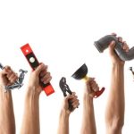 Multiple hands holding plumbing tools like a wrench, level, and paintbrush for Allore's Plumbing Services.